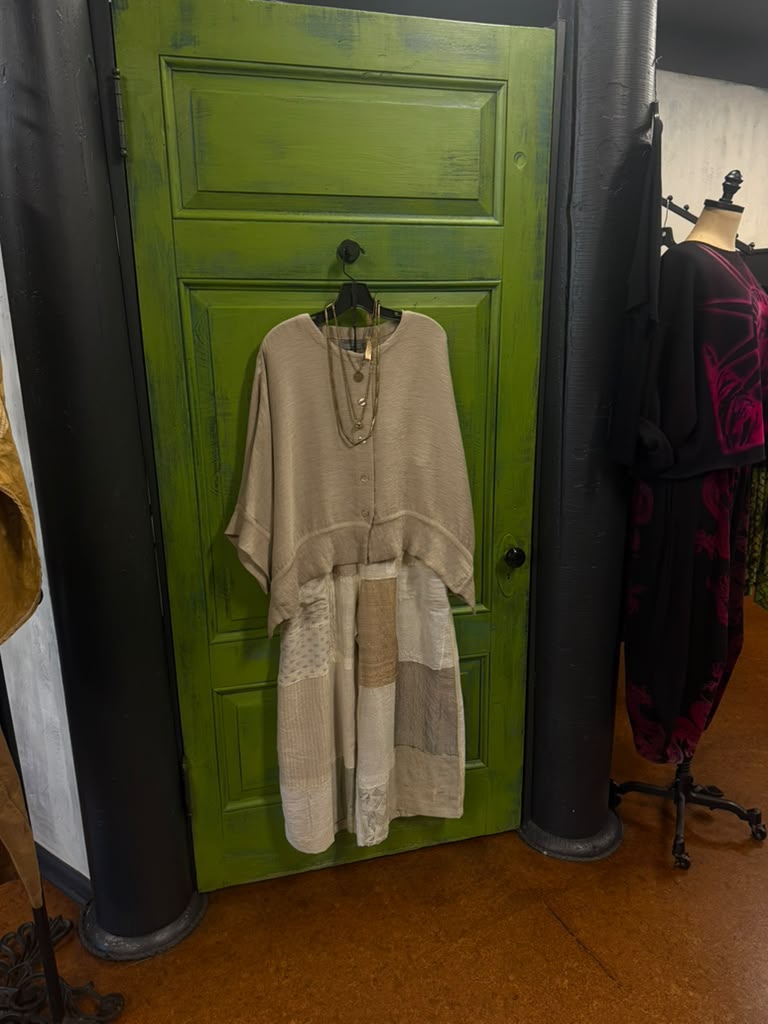 A dress hung on the green door at Gaia