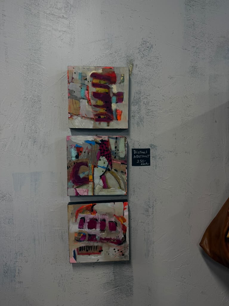 Paintings hung on the plaster wall at Gaia